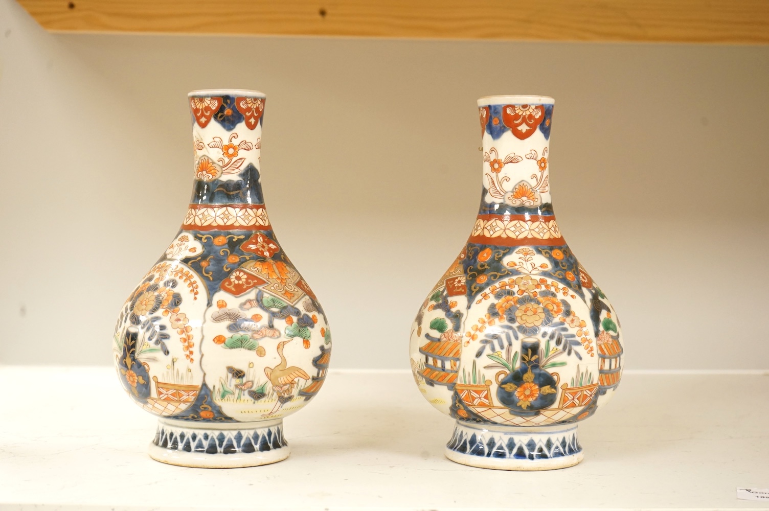 A pair of 19th century Japanese Imari bottle vases, 22cm high